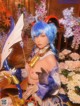 A woman with blue hair holding a bow and arrow.